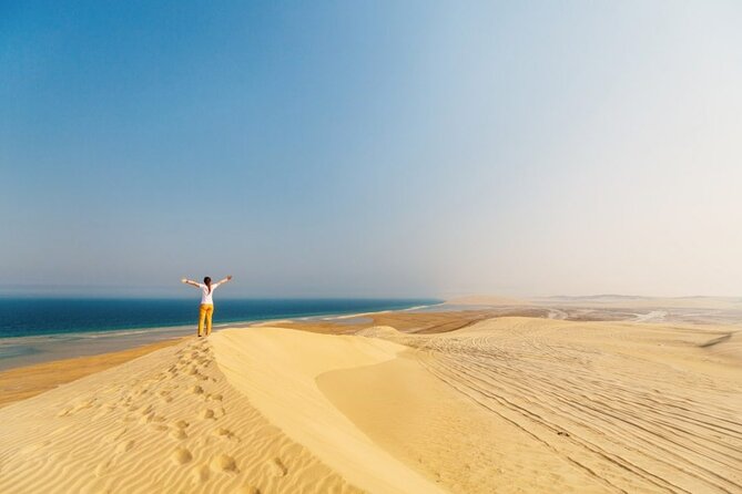 Doha Desert Safari Camel Ride, Sandboarding and Inland Sea - Sandboarding on Qatar’s golden dunes