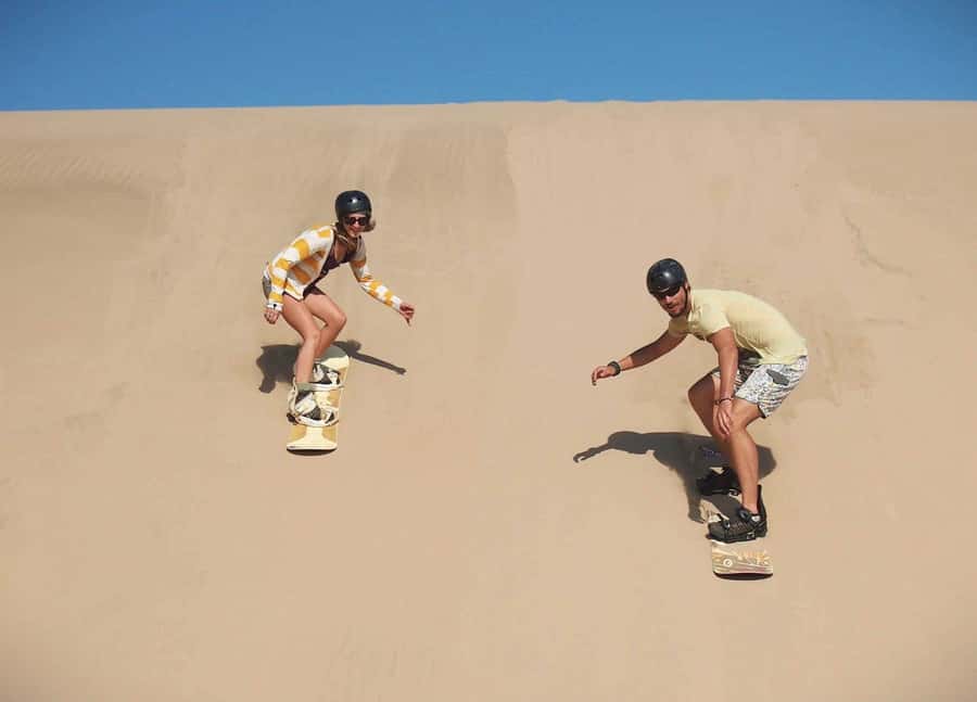 Doha Desert Safari: Sandboarding, Camel Ride & Swimming Fun - Sandboarding gives you a hands-on desert activity