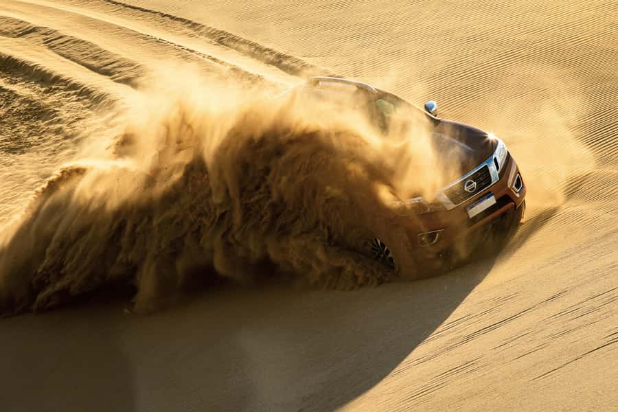 Doha Desert Safari: Sandboarding, Camel Ride & Swimming Fun - Dune bashing is thrilling, but not gentle