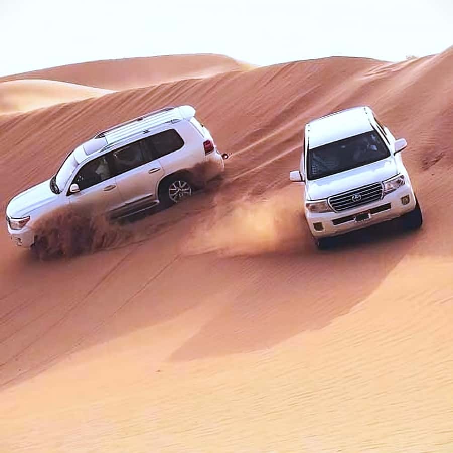 Doha Safari: ATV Ride, Dune Bashing, & Sandboarding Fun - Sandboarding and the view across Khor Al Udeid