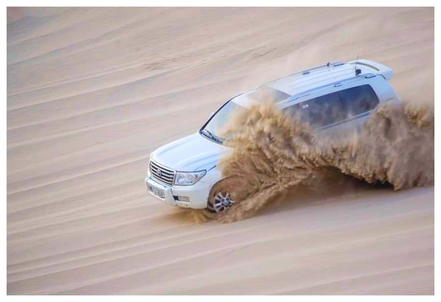 Dune Bashing, Sandboarding, Camel Ride & Optional ATV Ride - Dune bashing across Qatar’s golden dunes
