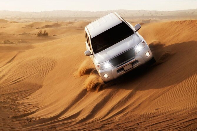 Full-Day DesertSafari with Camel Ride,InlandSea & BBQ Desert Camp - Dune bashing across the sand
