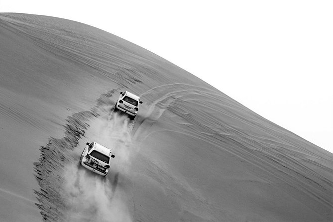 Sharing or Private Safari, Sand Boarding, Camel Ride, inland Sea Quick swim - Sandboarding from the dunes